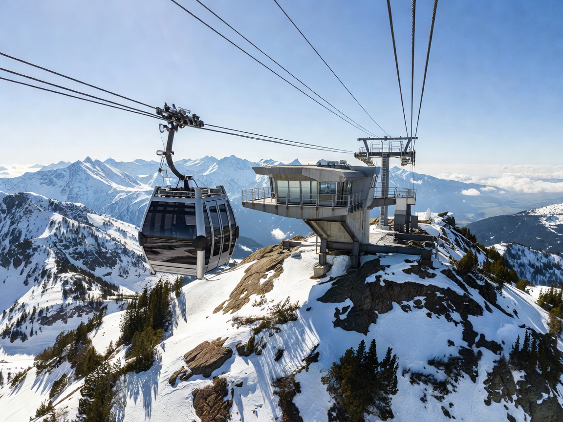Modern aerial cable car ascending toward a rugged alpine summit platform